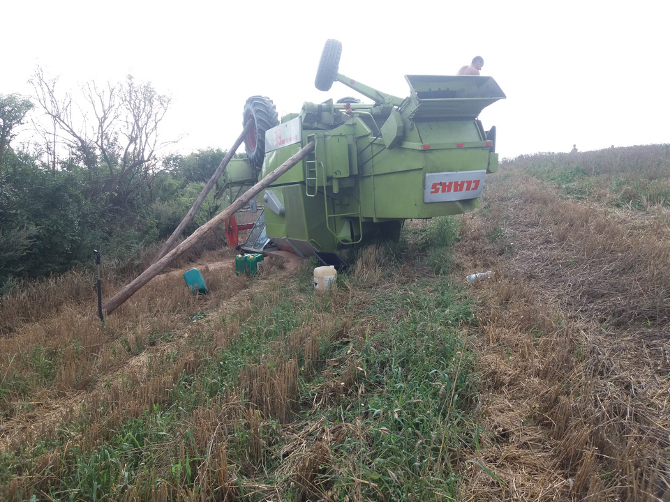 W gminie Krasnystaw (woj. lubelskie) rolnik próbował wjechać kombajnem na wzniesienie, niestety maszyna przewróciła się do góry kołami, 2018 r. fot. KWP w Lublinie